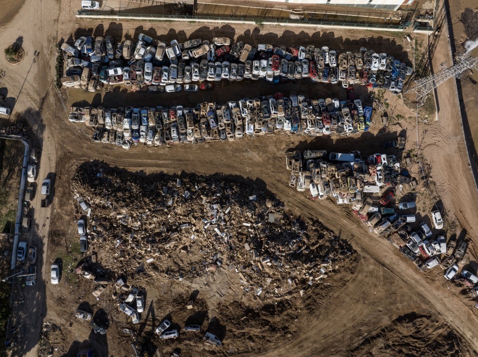an aerial view of a parking lot with lots of cars and trucks
