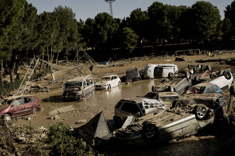 a bunch of cars are laying on their side in the mud