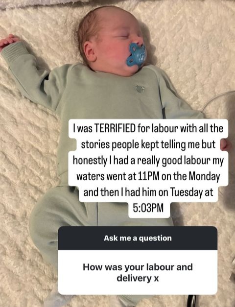 a baby with a pacifier laying on a bed