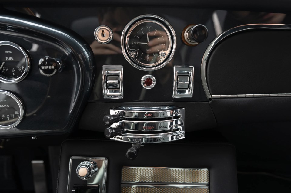 a car dashboard with a wiper gauge and a fuel gauge