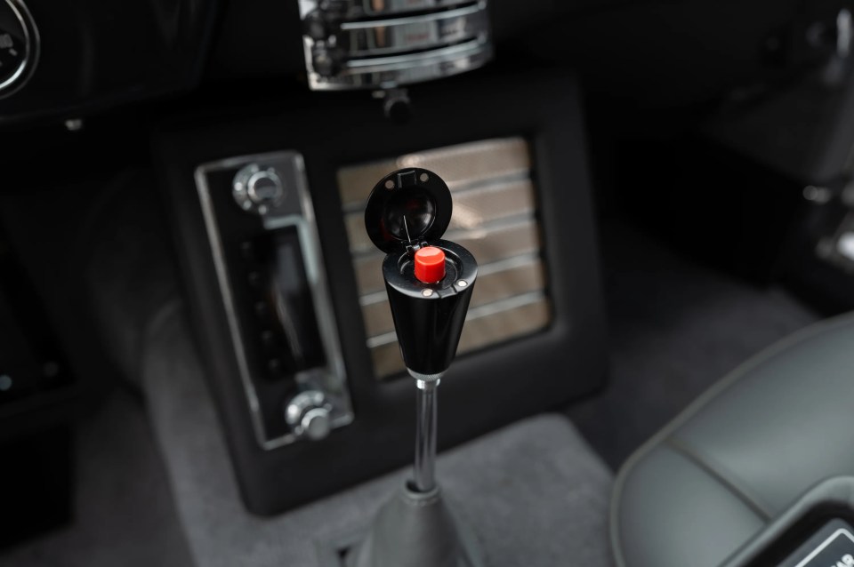 a car shifter with a red button on it