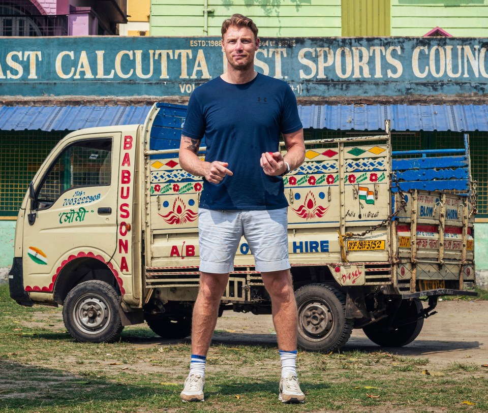 a man stands in front of a truck that says hire