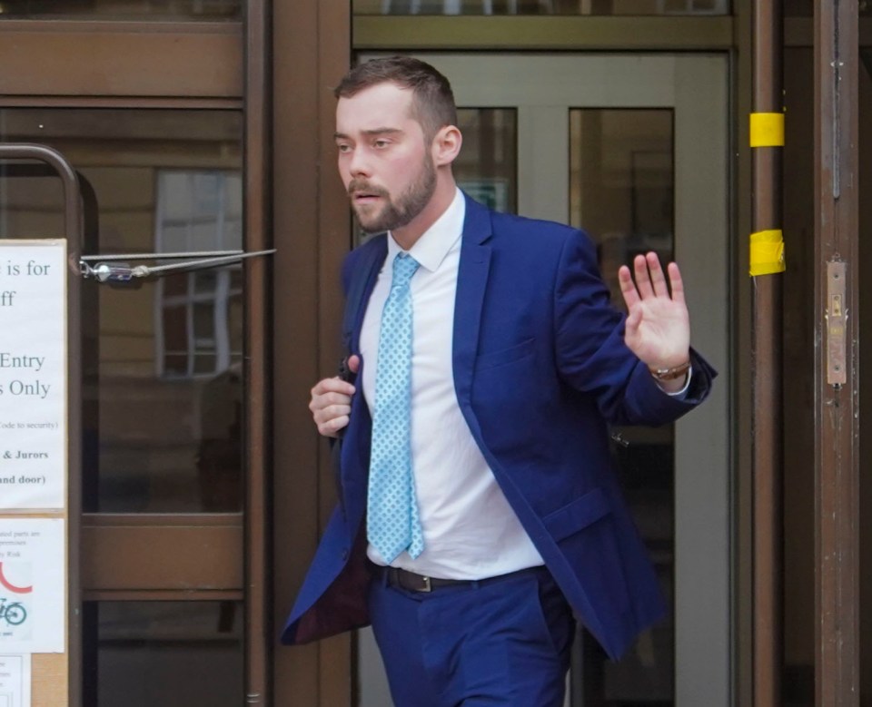 a man in a blue suit is walking out of a building