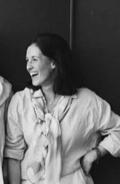 four women are standing next to each other and laughing