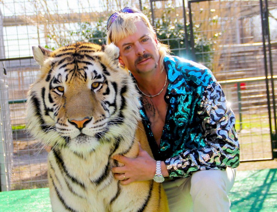 (FILES) In this file photo taken on January 20, 2020 this undated photo courtesy of Netflix shows Joseph "Joe Exotic" Maldonado-Passage with one of his tigers. - Joe Exotic is behind bars but Netflix has forged ahead with "Tiger King 2," a follow-up to the early-pandemic TV phenomenon, which has already spawned a legal battle before its release November 17, 2021. (Photo by Netflix US / AFP) / RESTRICTED TO EDITORIAL USE - MANDATORY CREDIT "AFP PHOTO / NETFLIX" - NO MARKETING - NO ADVERTISING CAMPAIGNS - DISTRIBUTED AS A SERVICE TO CLIENTS / TO GO WITH AFP STORY by Paul HANDLEY, "'Tiger King': true-crime tale of 'Joe Exotic' grips shut-in nation" (Photo by -/Netflix US/AFP via Getty Images)