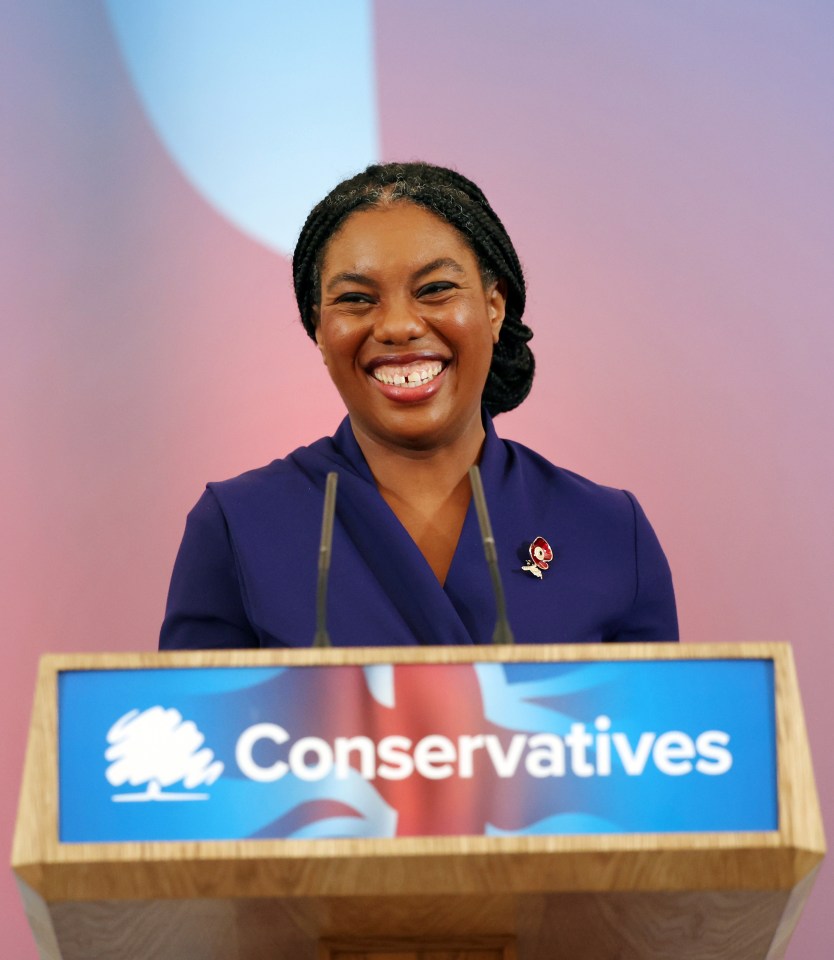 a woman stands behind a podium that says conservatives