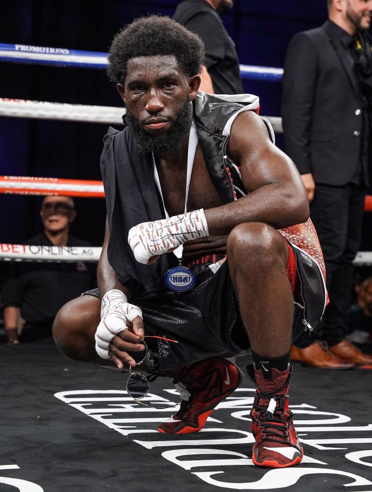 a man in a boxing ring with a medal that says ibb on it