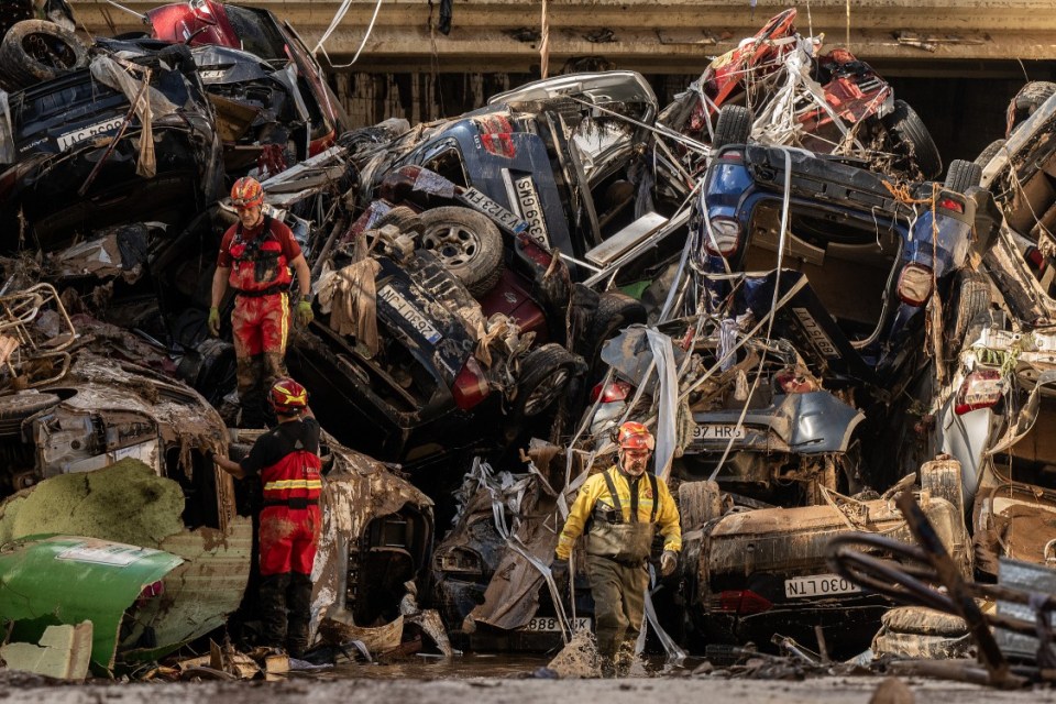VALENCIA, SPAIN - NOVEMBER 1: Members of the fire brigade, which are part of a search and rescue unit, carry out work as cars and debris block a tunnel on the border of Benetusser and Alfafar municipalities after the recent flash flooding on November 1, 2024 on the border of Benetusser and Alfafar municipalities of Valencia, Spain. By Friday morning, Spanish authorities confirmed that at least 200 people had died, mostly in the Valencia region, amid the flooding that swept eastern and southern parts of the country starting on Tuesday. The intense rainfall event is known as a "cold drop" or DANA weather system. (Photo by David Ramos/Getty Images)