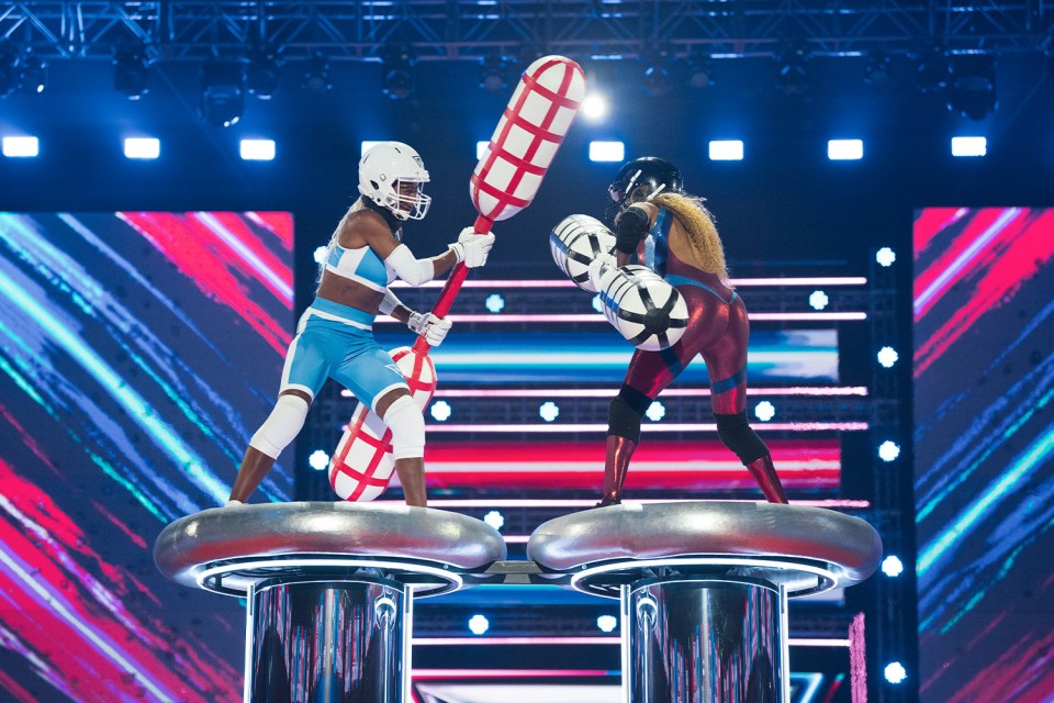 a man and a woman are playing a game on a stage