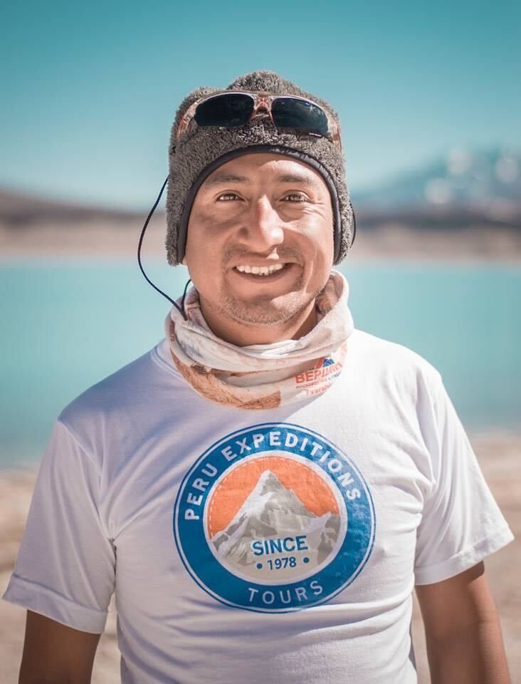 a man wearing a peru expeditions shirt smiles for the camera