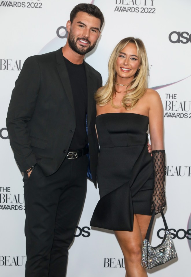 a man and woman pose for a photo at the beauty awards