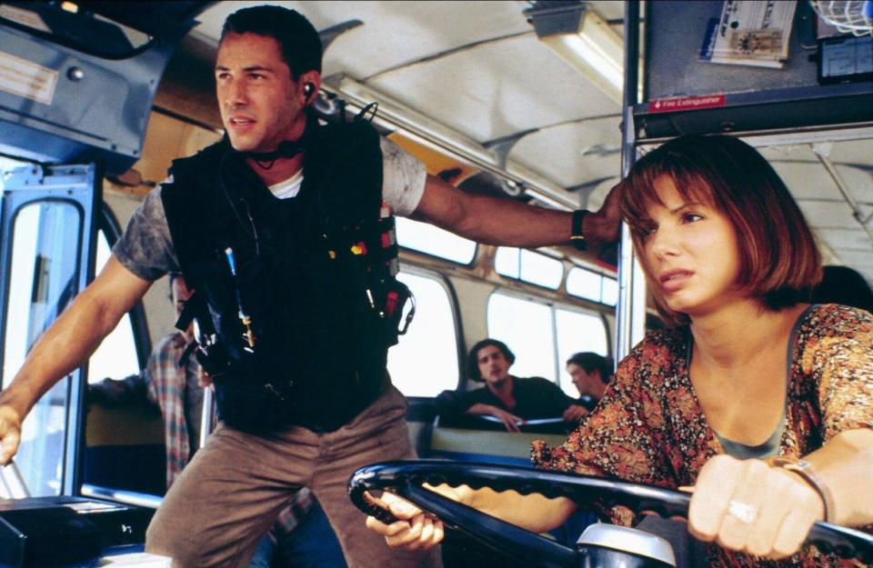 a man and a woman on a bus with a sign on the wall that says fire escape