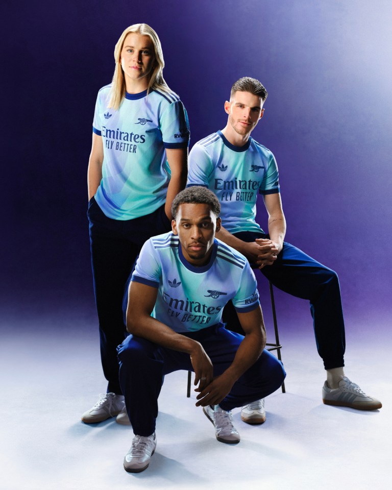 a group of people wearing emirates fly better shirts
