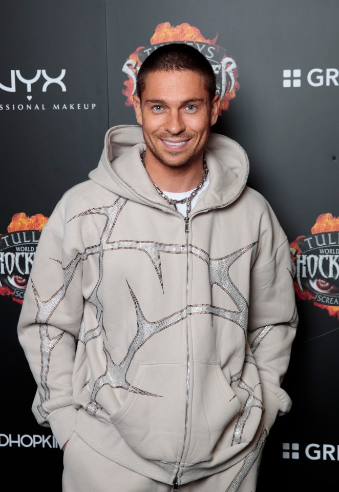 a man standing in front of a wall that says nyx professional makeup