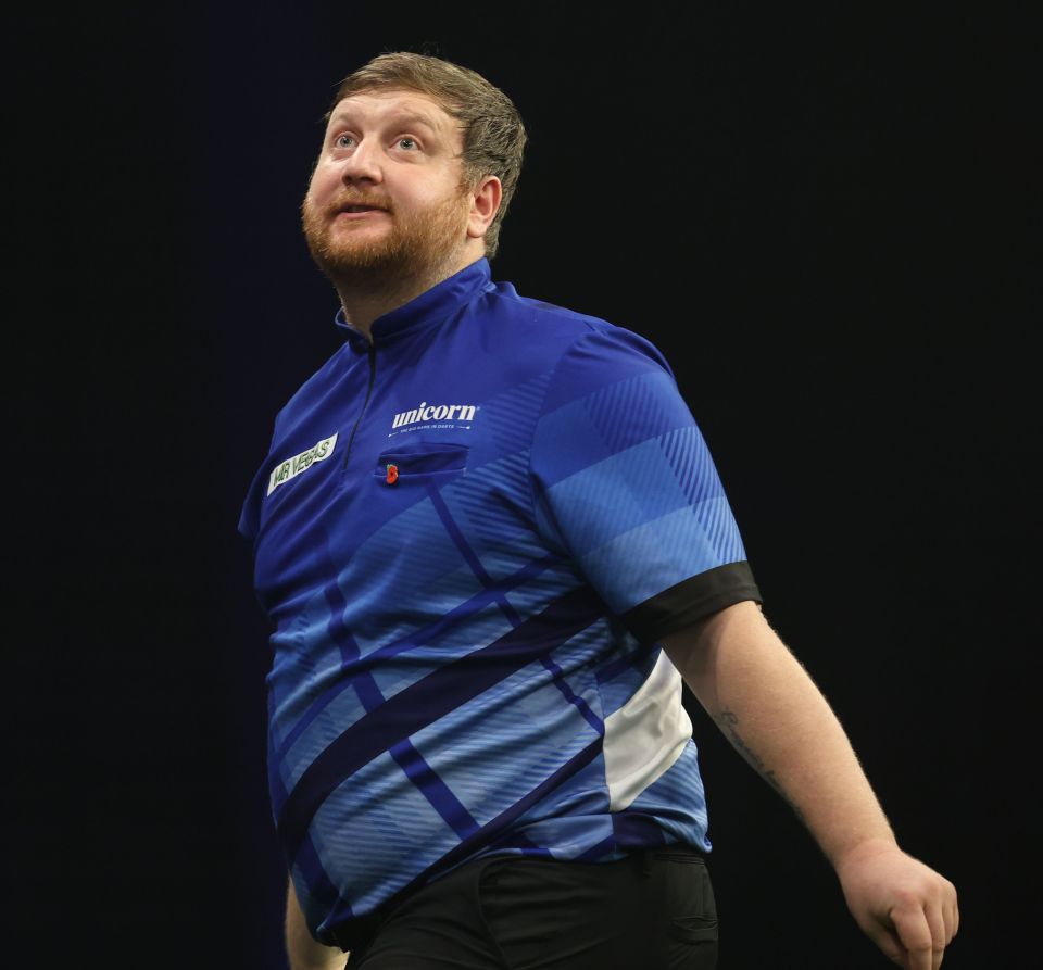 a man wearing a blue shirt that says unicorn on it