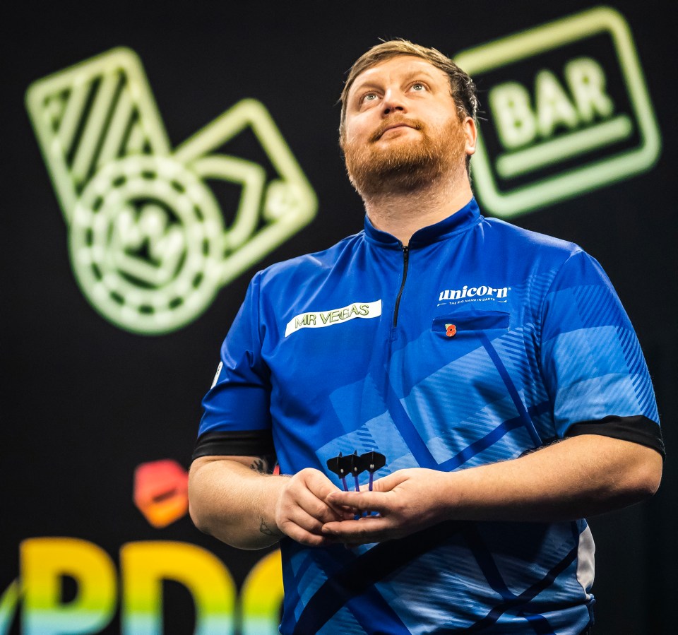 a man wearing a blue shirt that says unicorn on it