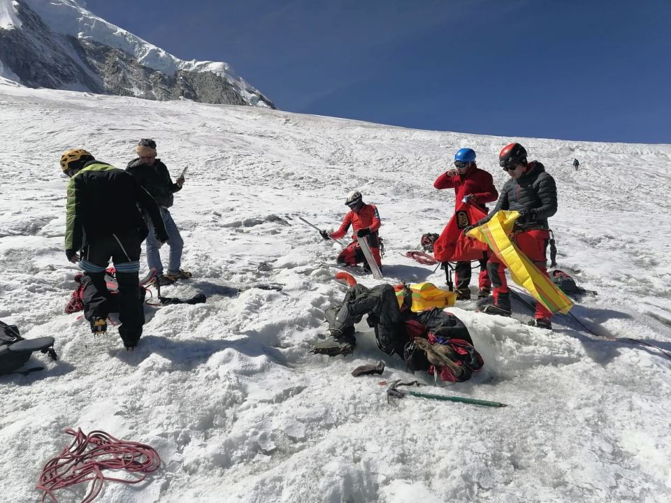 a group of people are standing on a snowy mountain