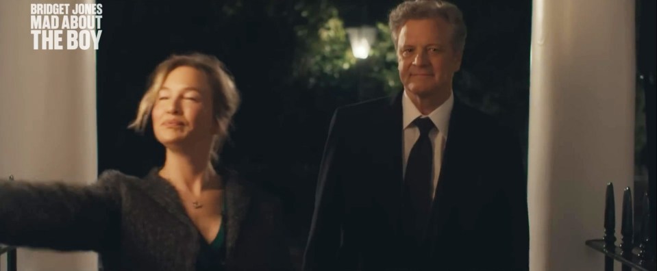a man and a woman are standing in front of a sign that says bridget jones mad about the boy