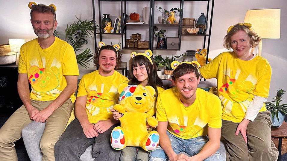 a group of people wearing yellow shirts with teddy bears on them