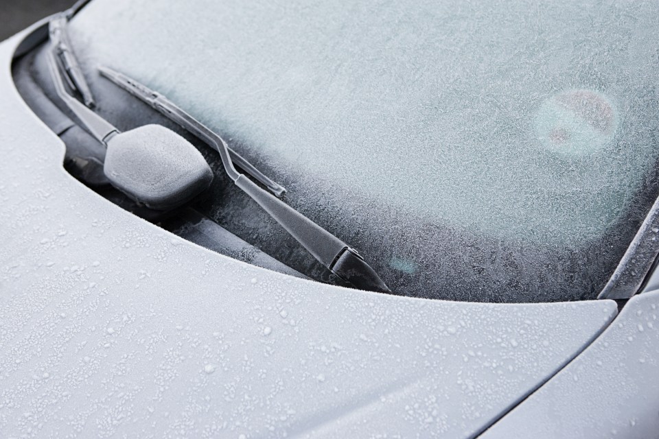the windshield of a car is covered in frost