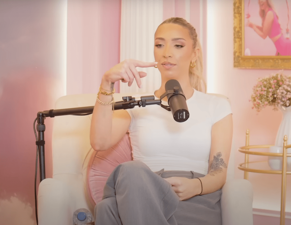 a woman is sitting in front of a microphone that says ' yamaha ' on it