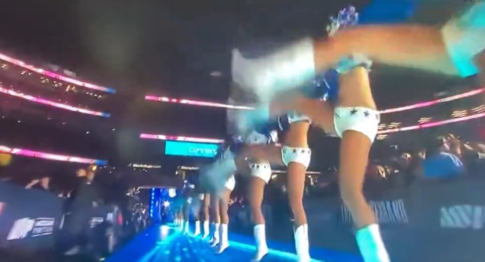a group of cheerleaders are performing in a stadium with a sign that says connect
