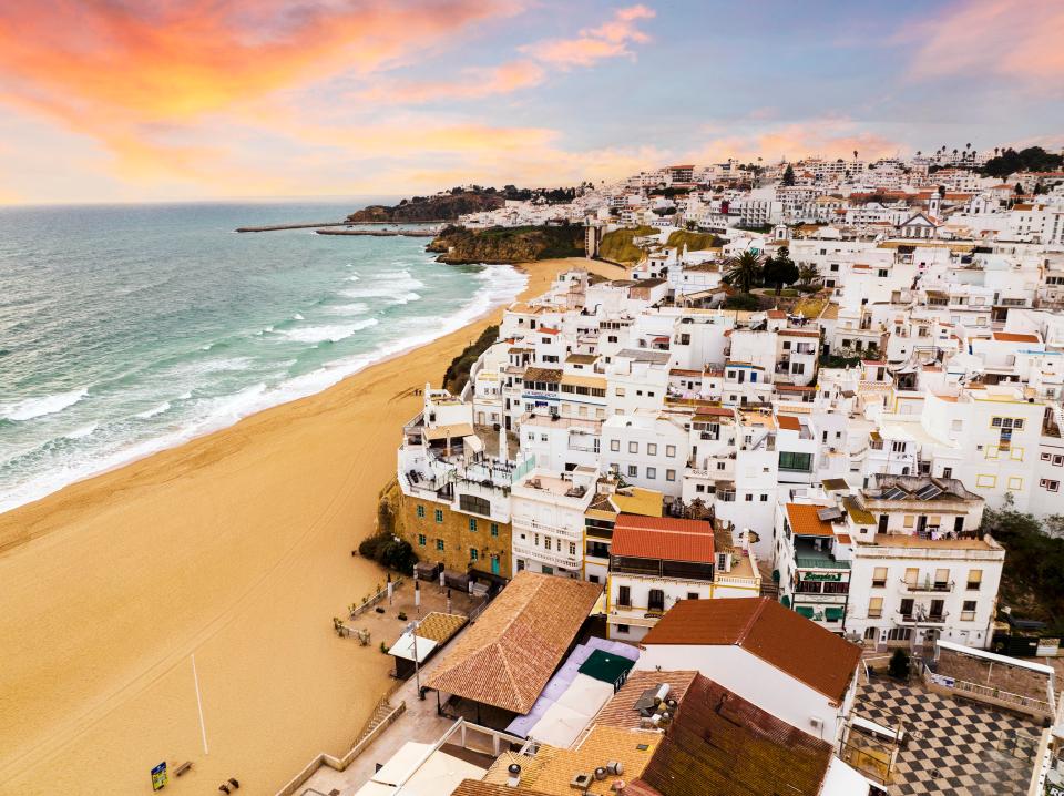 an aerial view of a small town next to the ocean