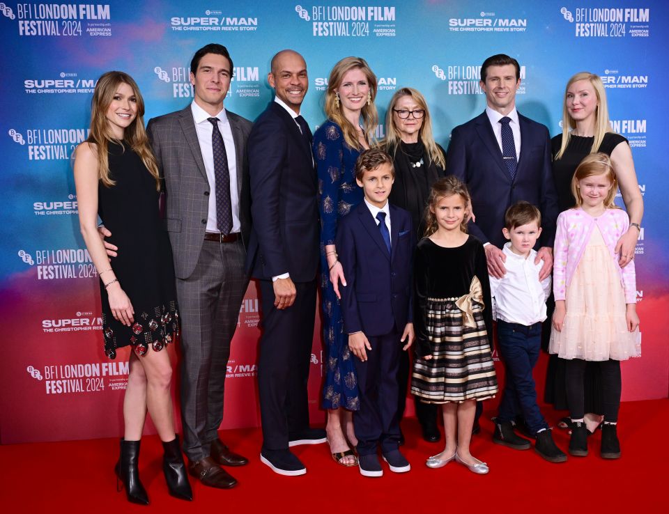 a group of people standing on a red carpet at the bfi london film festival