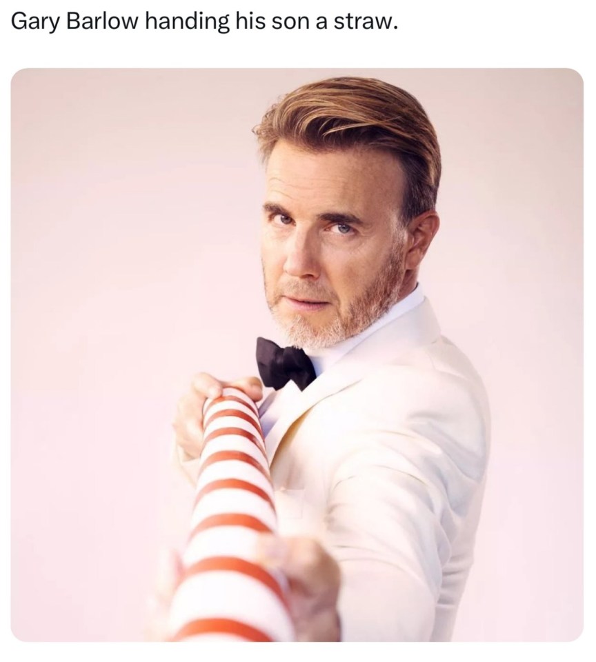 a picture of gary barlow handing his son a straw