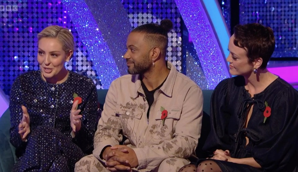 three people are sitting on a couch with a bbc logo in the background