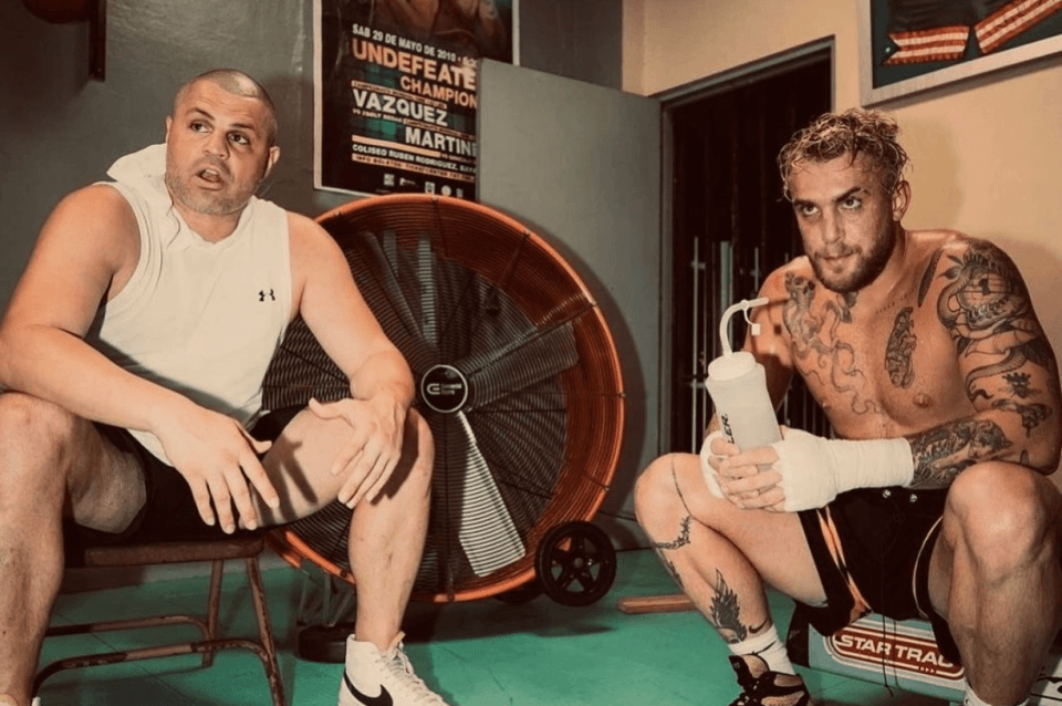 two men are squatting down in front of a poster that says underfeate