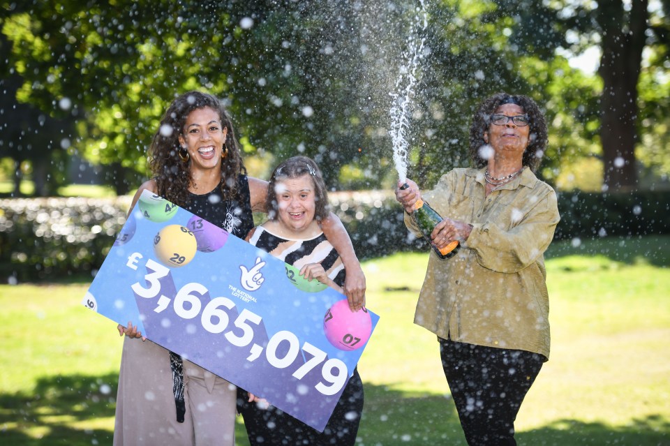 a woman holding a lottery ticket with the number 3 on it