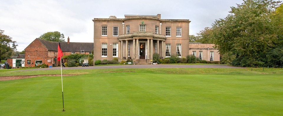 a large building with a green in front of it
