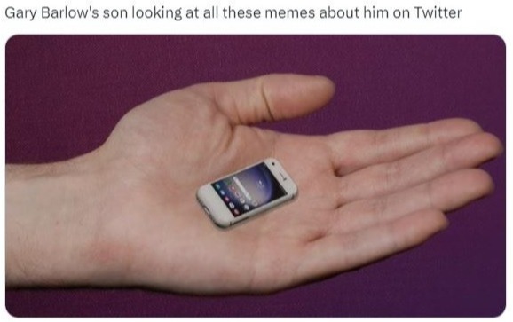 a person holding a small cell phone in their hand