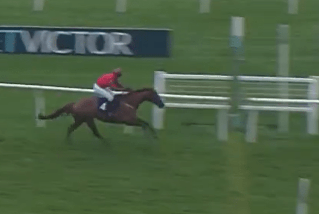 a jockey is riding a horse in a race with a tvctor sign in the background