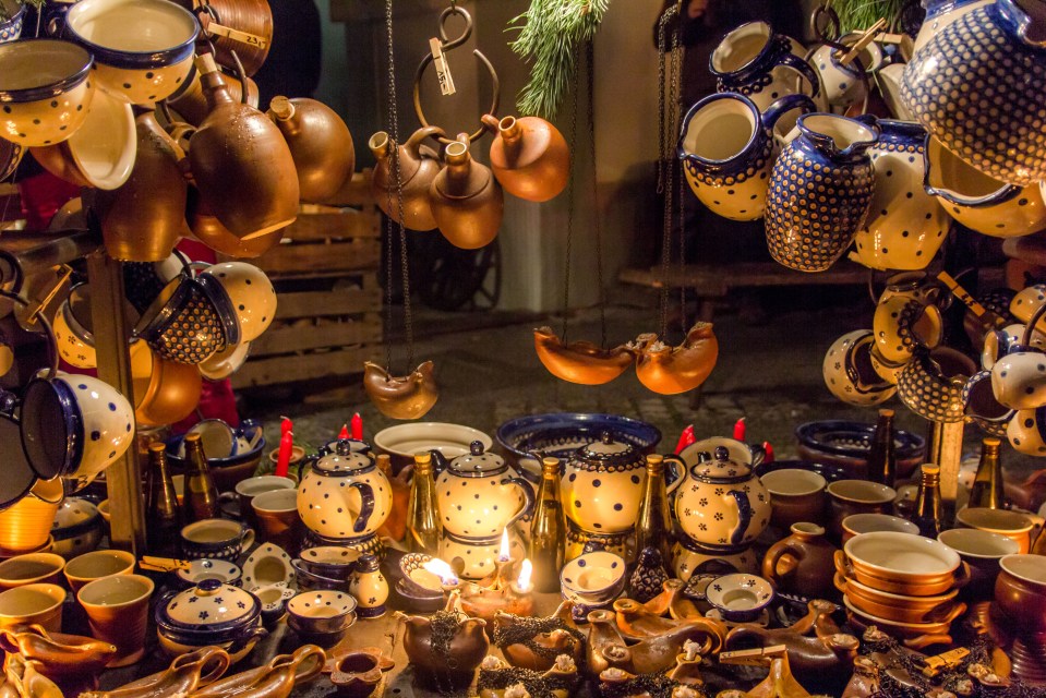 a display of pottery with a tag that says ' handmade ' on it