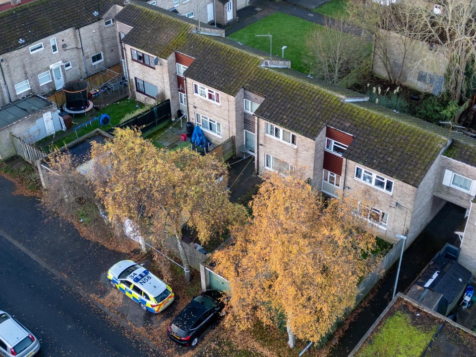 an aerial view of a police car parked in front of a house