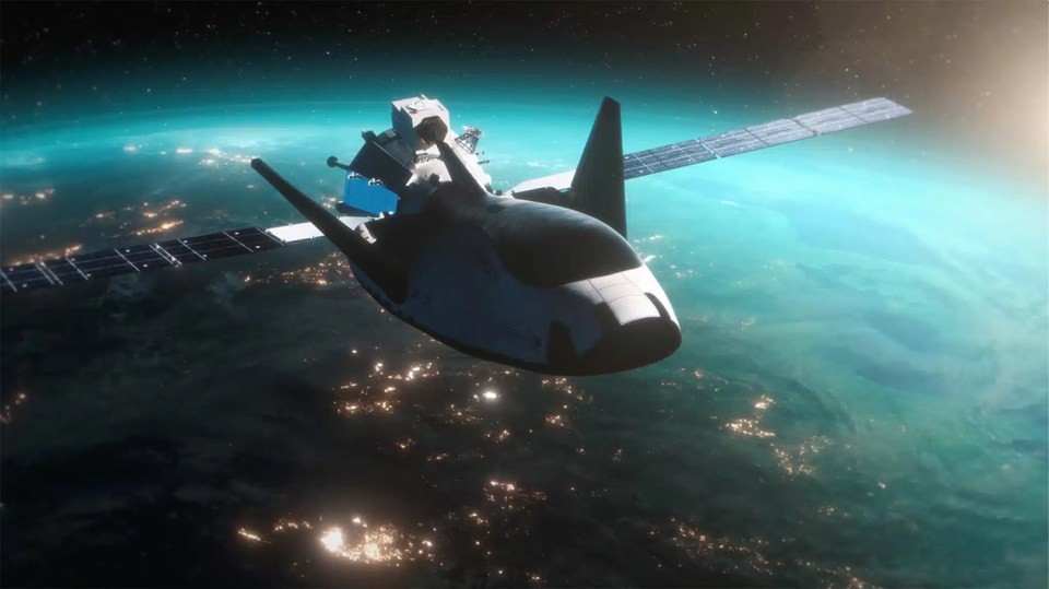 an artist 's impression of a space shuttle approaching a satellite