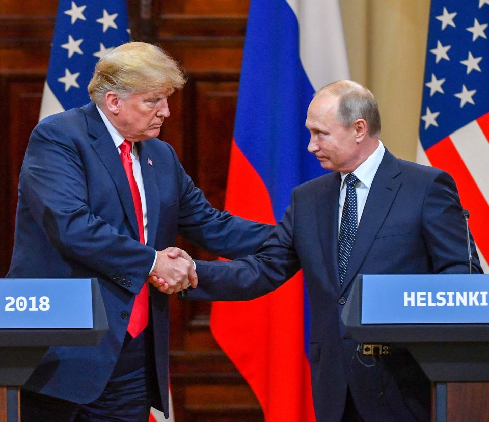 two men shaking hands in front of a podium that says helsinki 2018