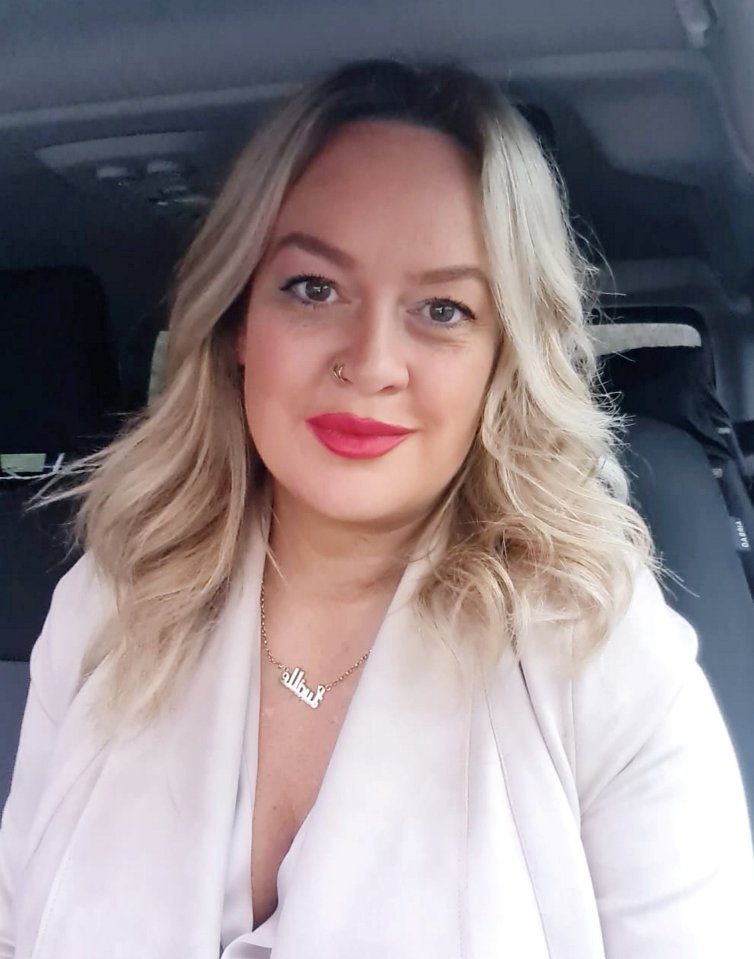 a woman wearing a white jacket and a necklace with the name nathalie on it