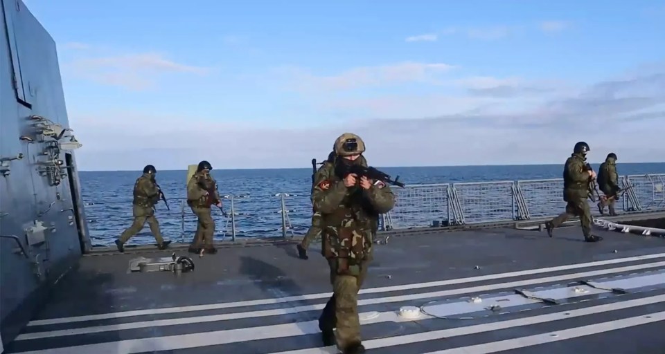 a group of soldiers walking on a deck with a zvezdanews logo in the corner