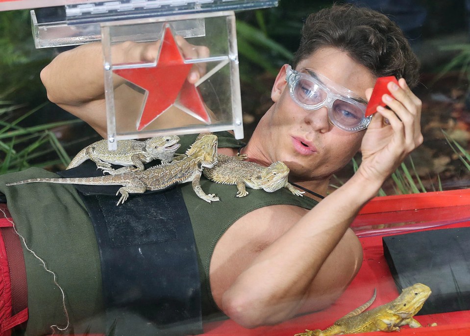 a man with a red star on his chest is surrounded by lizards