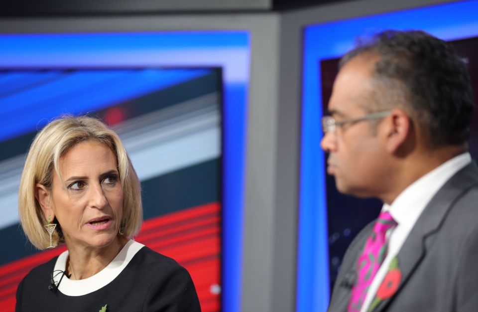 a man and a woman are talking in front of a blue screen