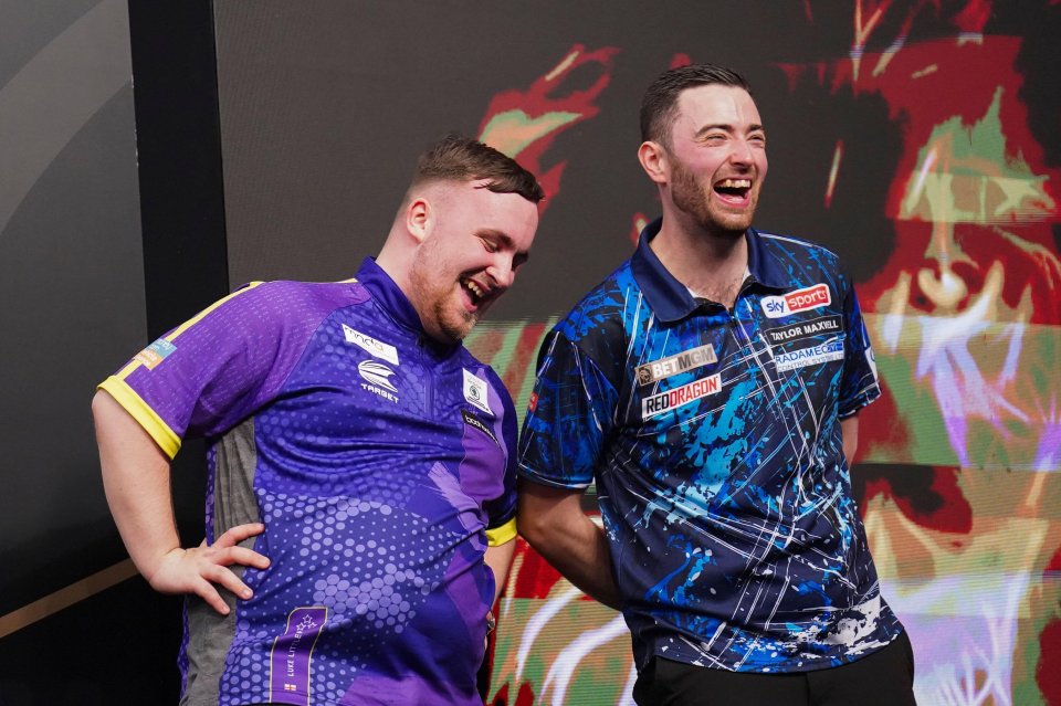 two men are laughing and one has a shirt that says sky sports on it