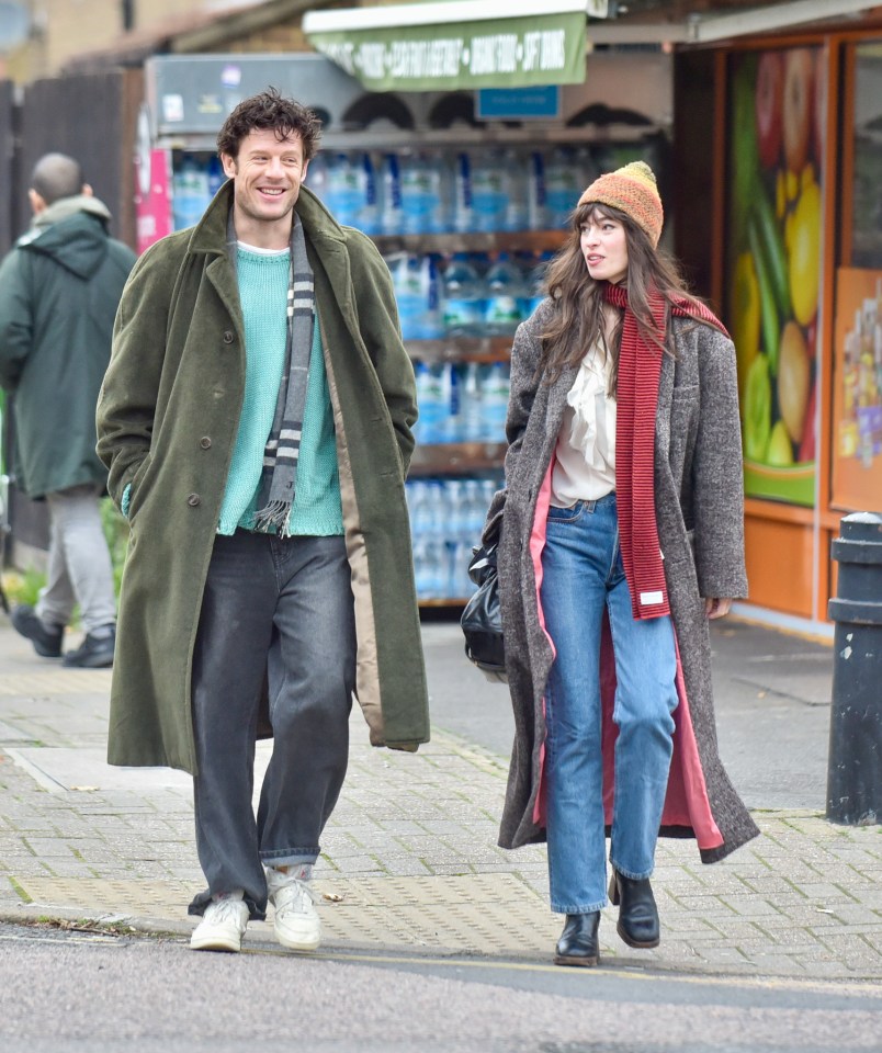 a man and a woman are walking down a sidewalk in front of a store that sells bottled water