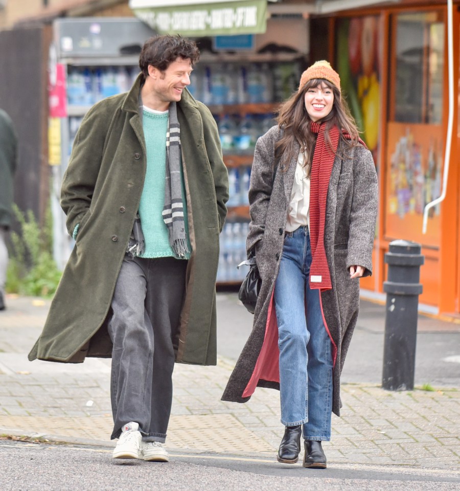 a man and a woman are walking down a sidewalk in front of a store that sells bottled water