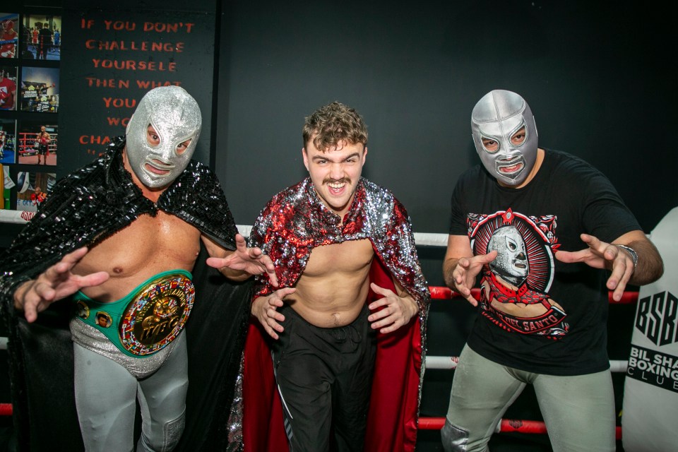 three wrestlers are posing in front of a sign that says if you don 't challenge yourself then what you won 't