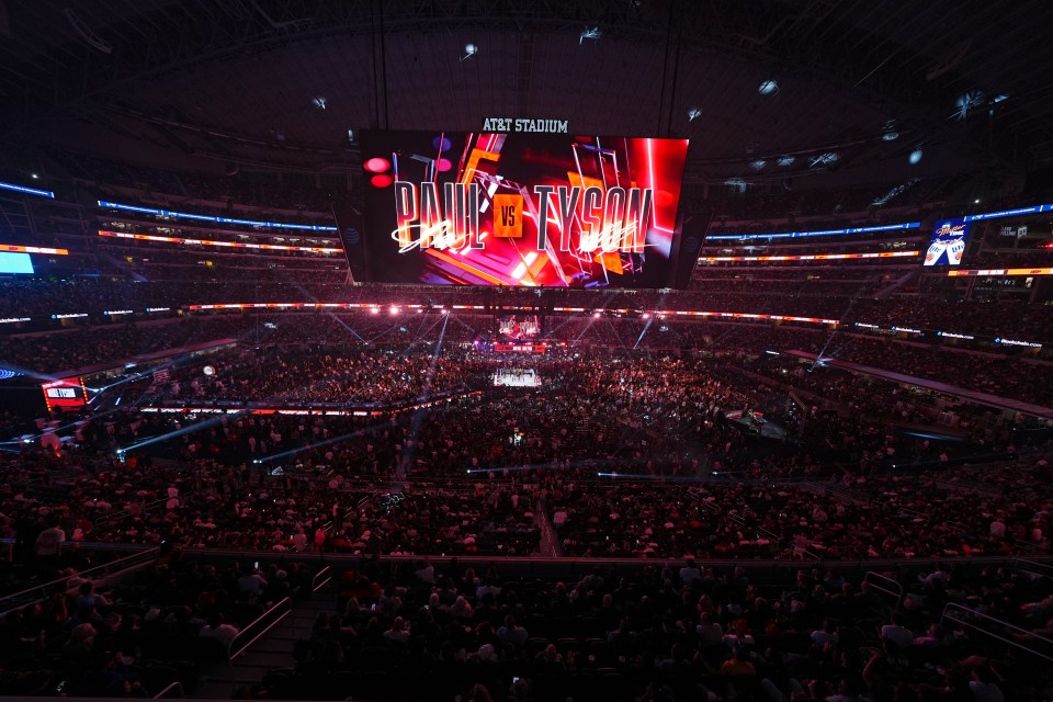 an at & t stadium filled with people watching a concert