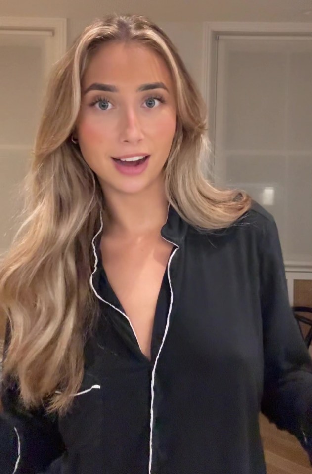 a woman is wearing a black shirt with white trim