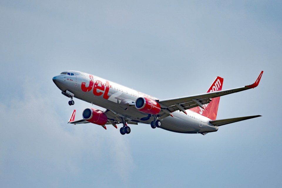 a jet airplane is flying through the air